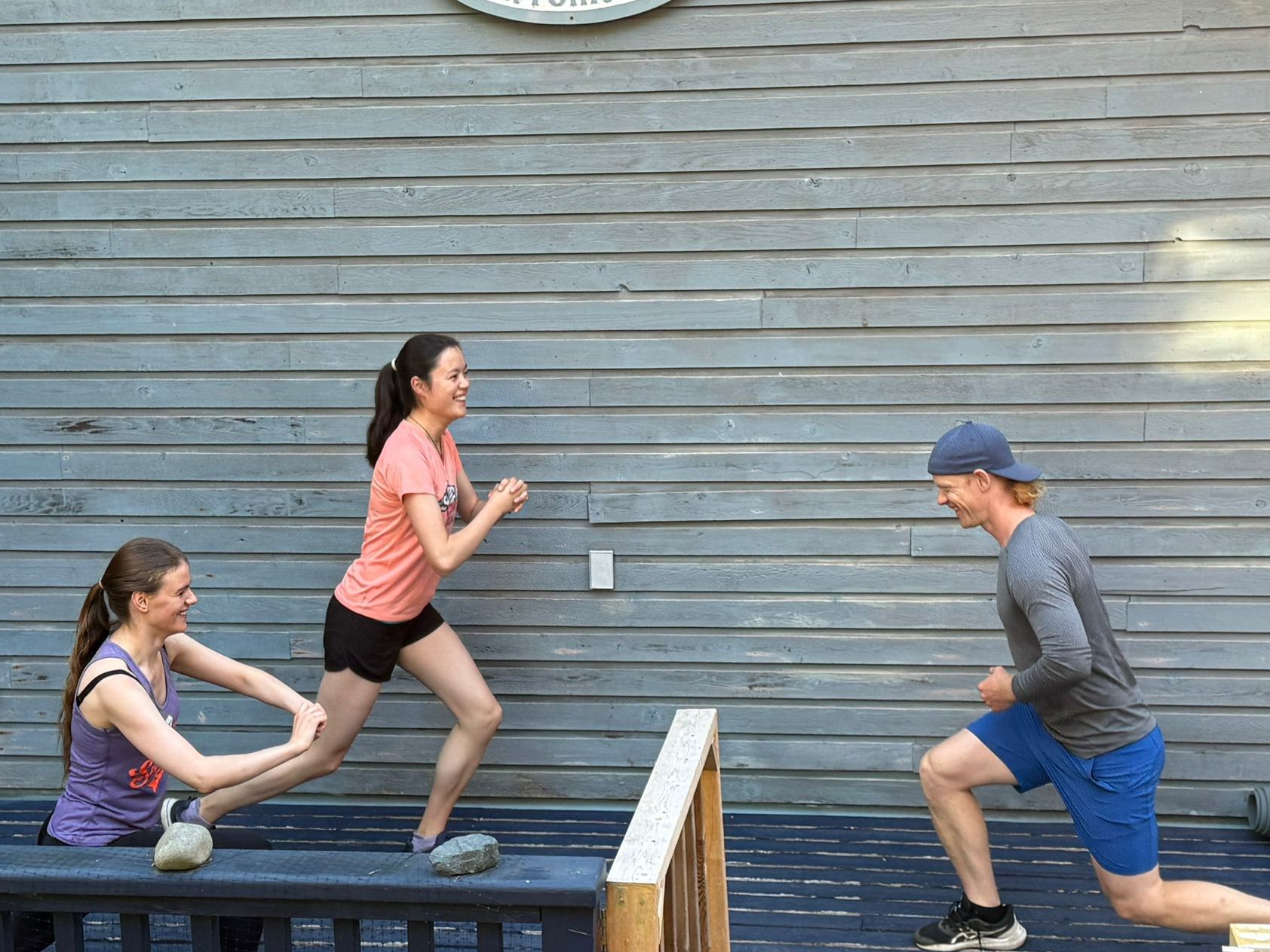 Small group doing partner-assisted exercises outdoors during a Mayne Island personal training session